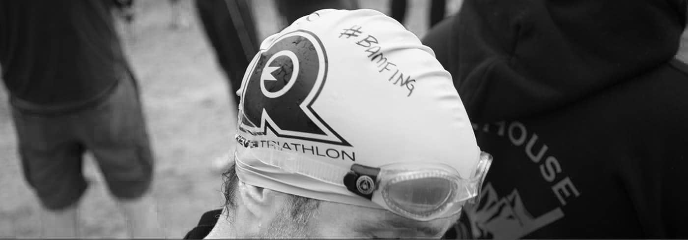 A close up of Jeff Boyer competing in a triathlon wearing a swim cap
